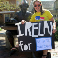 A student displays a sign showing her reason for participating in Relay for Life.