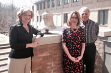 Amy Colley, assistant superintendent for curriculum and instruction at Poquoson City Public Schools, poses for a photo after ringing the bell at the School of Education with her dissertation committee chair Michael DiPaola and committee member Leslie Grant.  Doctoral students ring the bell after successfully defending their dissertations.