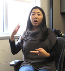 Ji Liu, a Ph.D. student in physics, explains how she worked underground at Fermilab, testing the PCV modules for the NoVA experiment.  Photo by Joseph McClain.