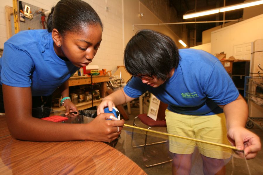 Two students working together on a service project