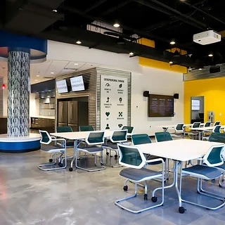 Main lobby with reconfigurable tables, large screens and modern decor