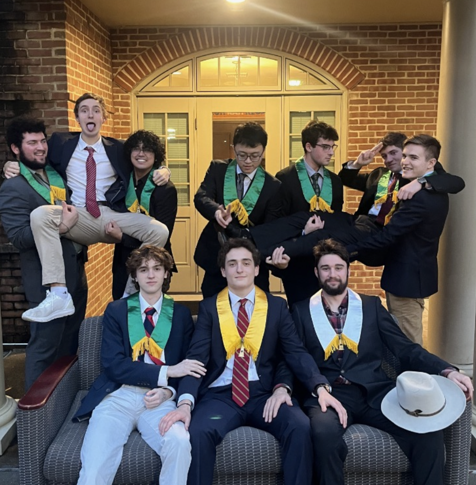 Alpha Tau Omega brothers pose in front of on-campus housing.