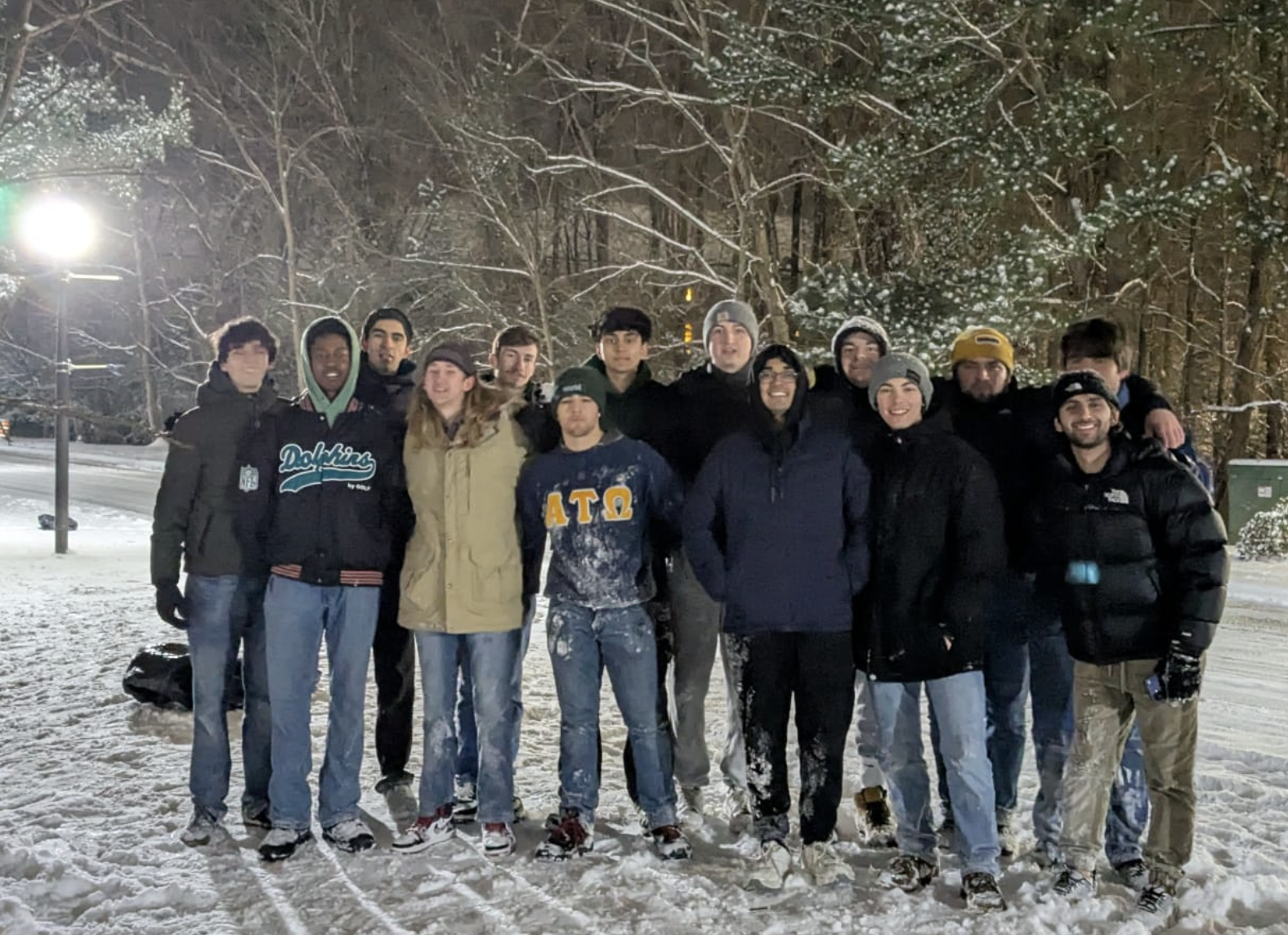 Alpha Tau Omega pose together in the snow.