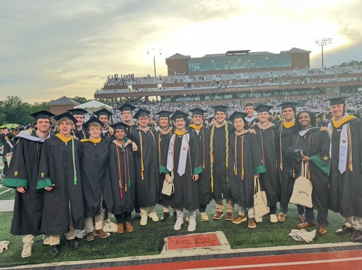 Delta Chi brothers pose together at graduation.