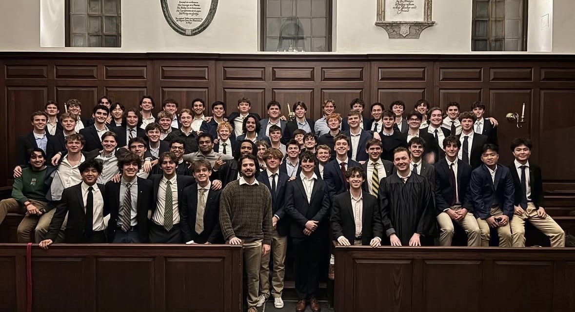 Delta Chi brothers pose together in the Great Hall.