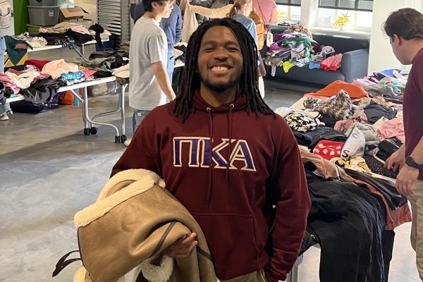 A Pi Kappa Alpha member poses for a photo at a community event.