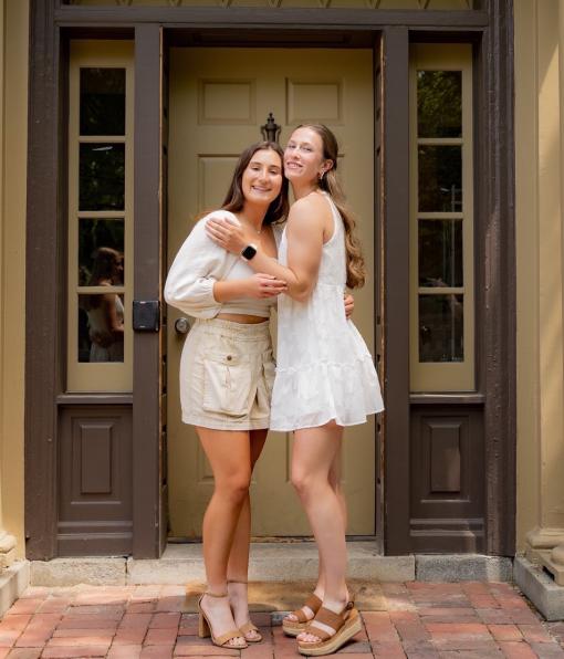 Two members smiling in an embrace 