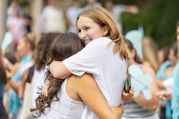 Two students embrace each other on Panhellenic Bid Day.