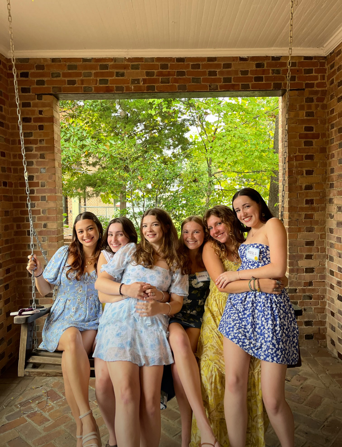 Tri Delta members on the patio swing