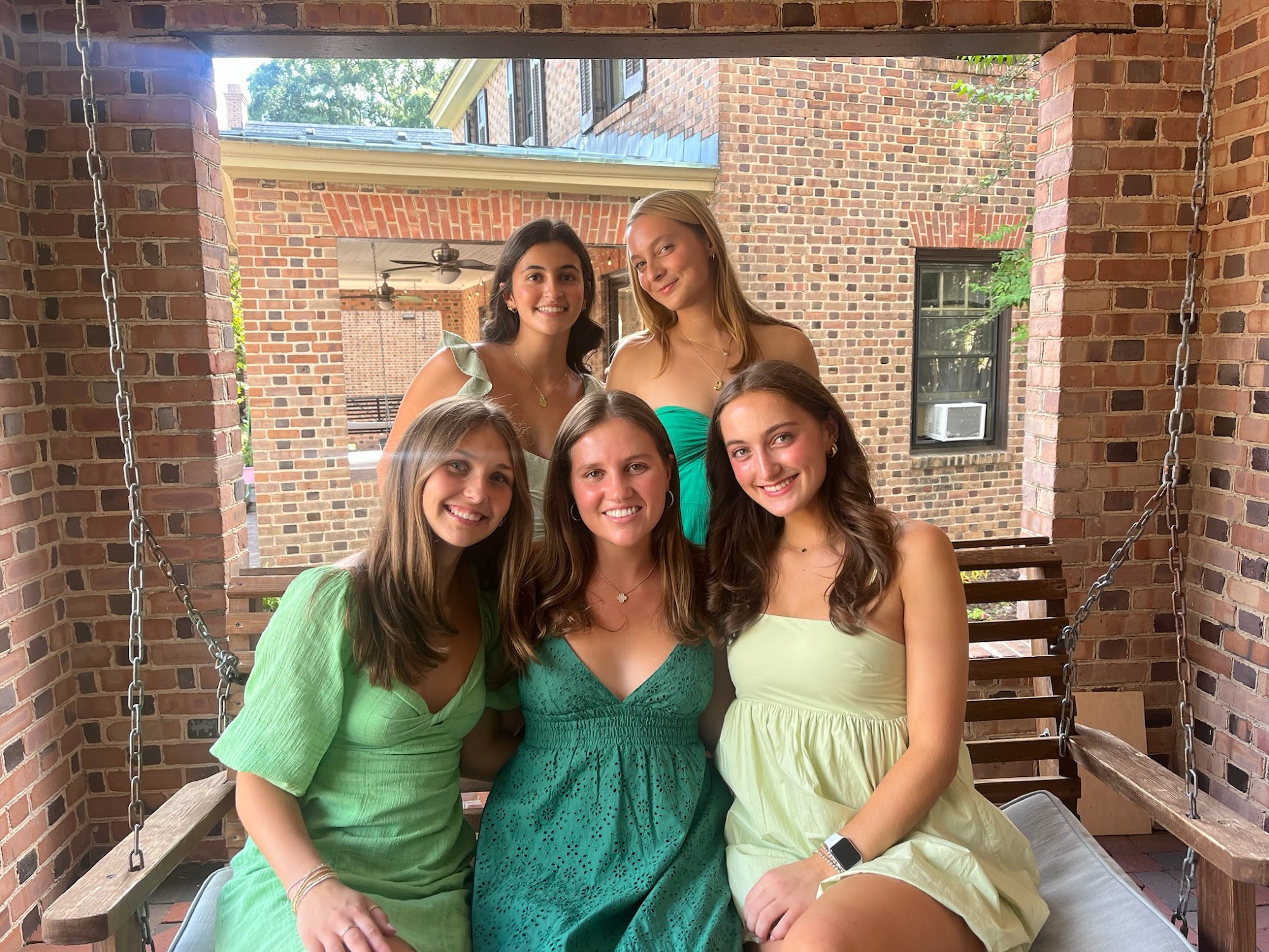 Pi Phi on bench on porch