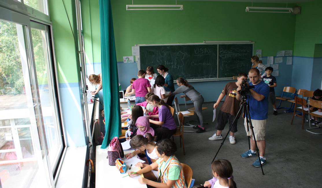 Adam Stackhouse '04 (with the camera) working with Bosnian students and co-teachers during the summer of 2010. 