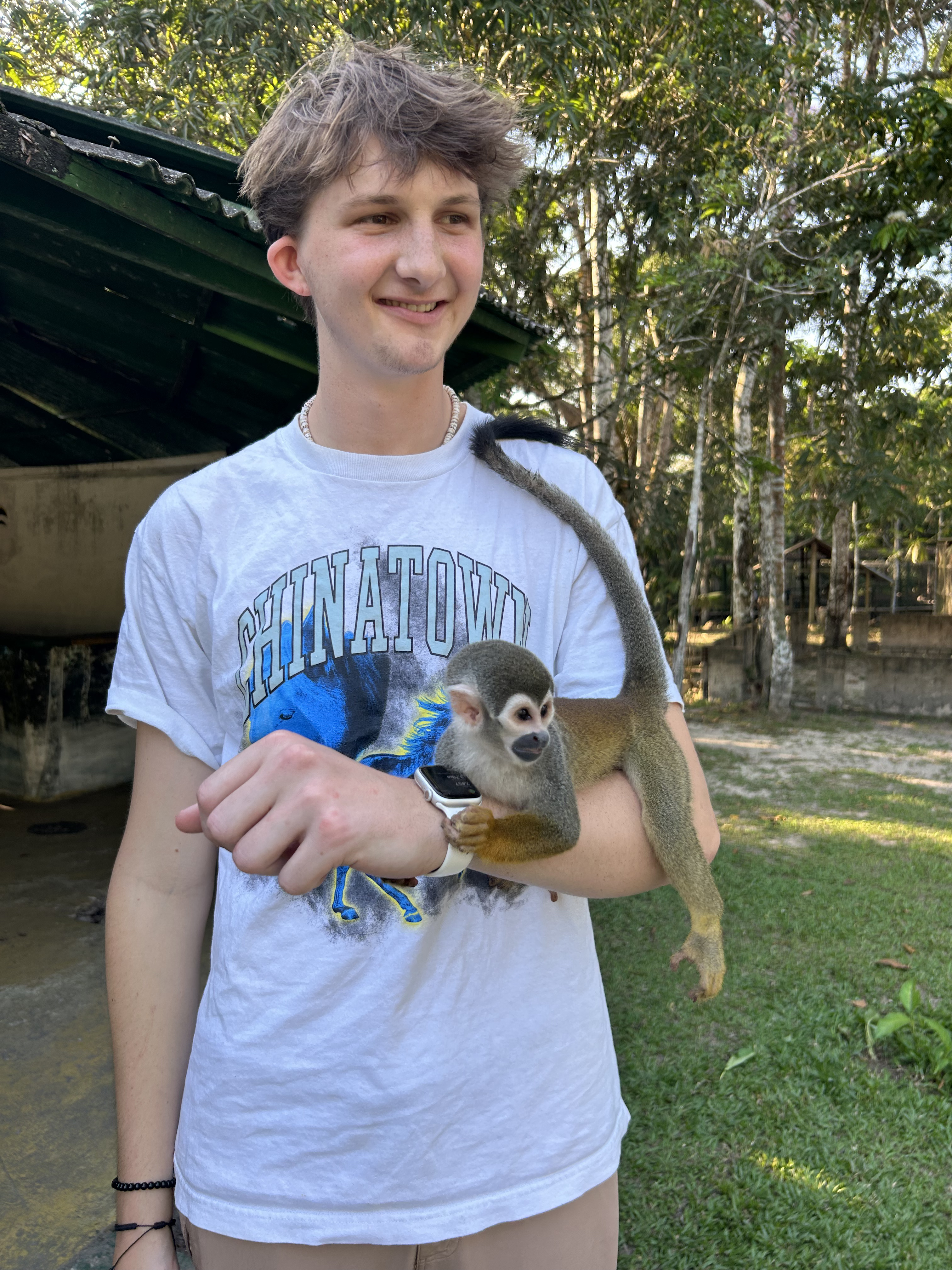 A Monkey lounging on Garrett at the Maikuchiga Monkey Sanctuary