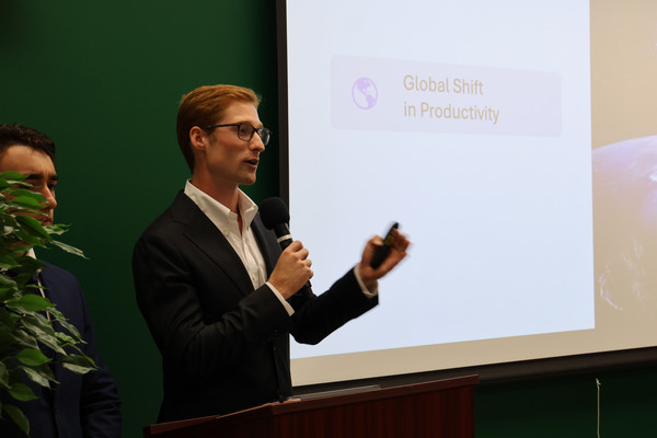 A person gives a presentation on the global shift in productivity.