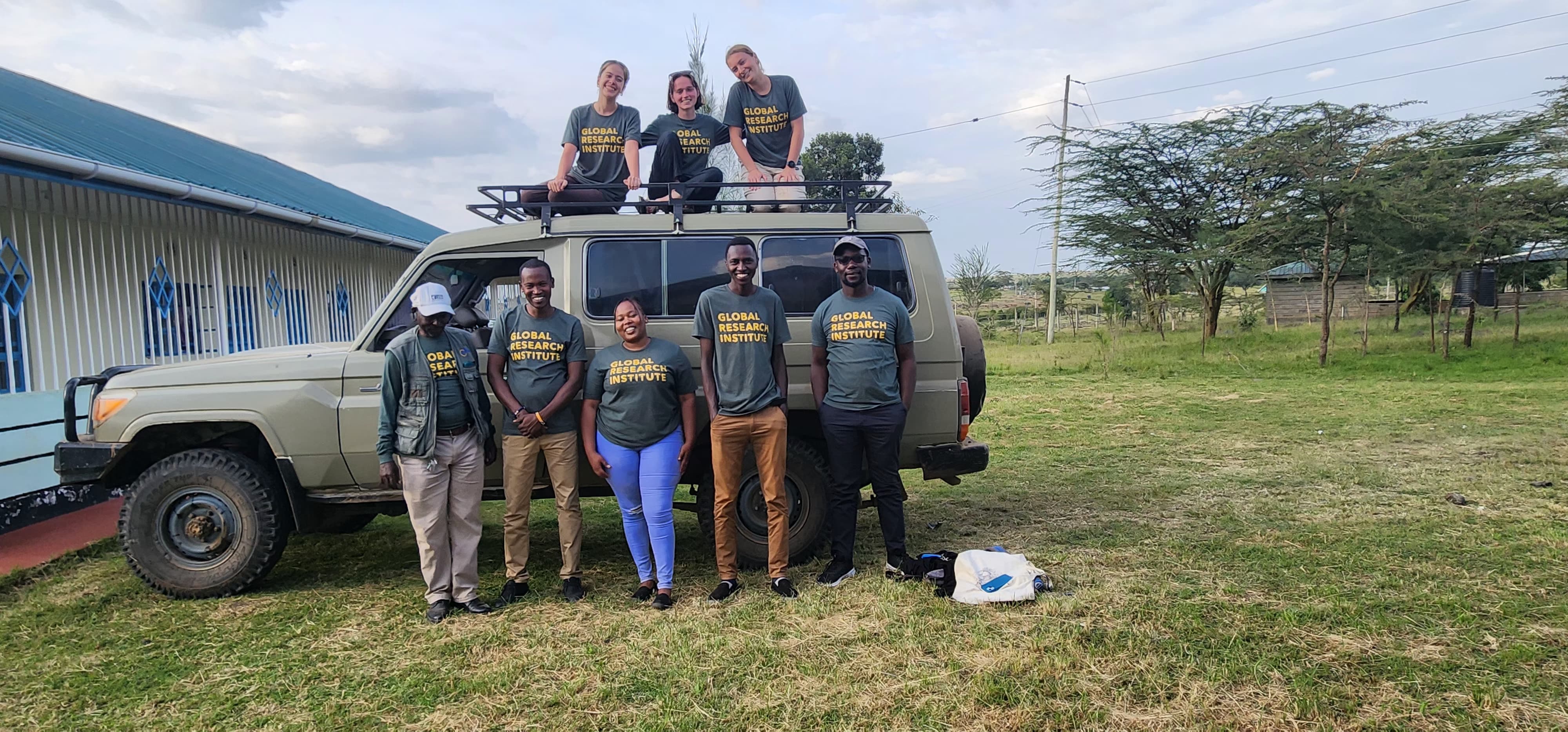 GRI shirts in front of a truck in Africa. 
