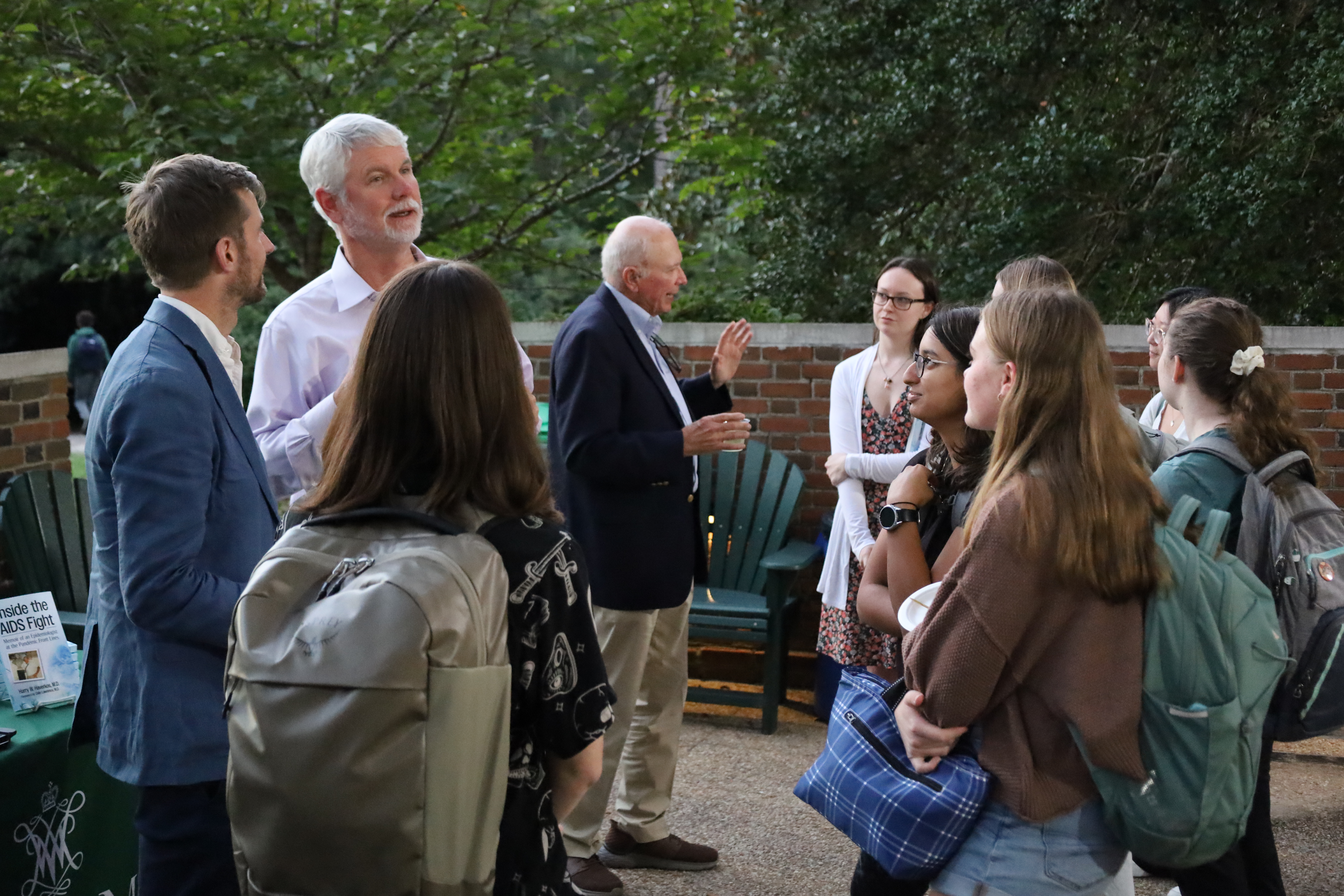 Guests enjoy food outside after a book launch