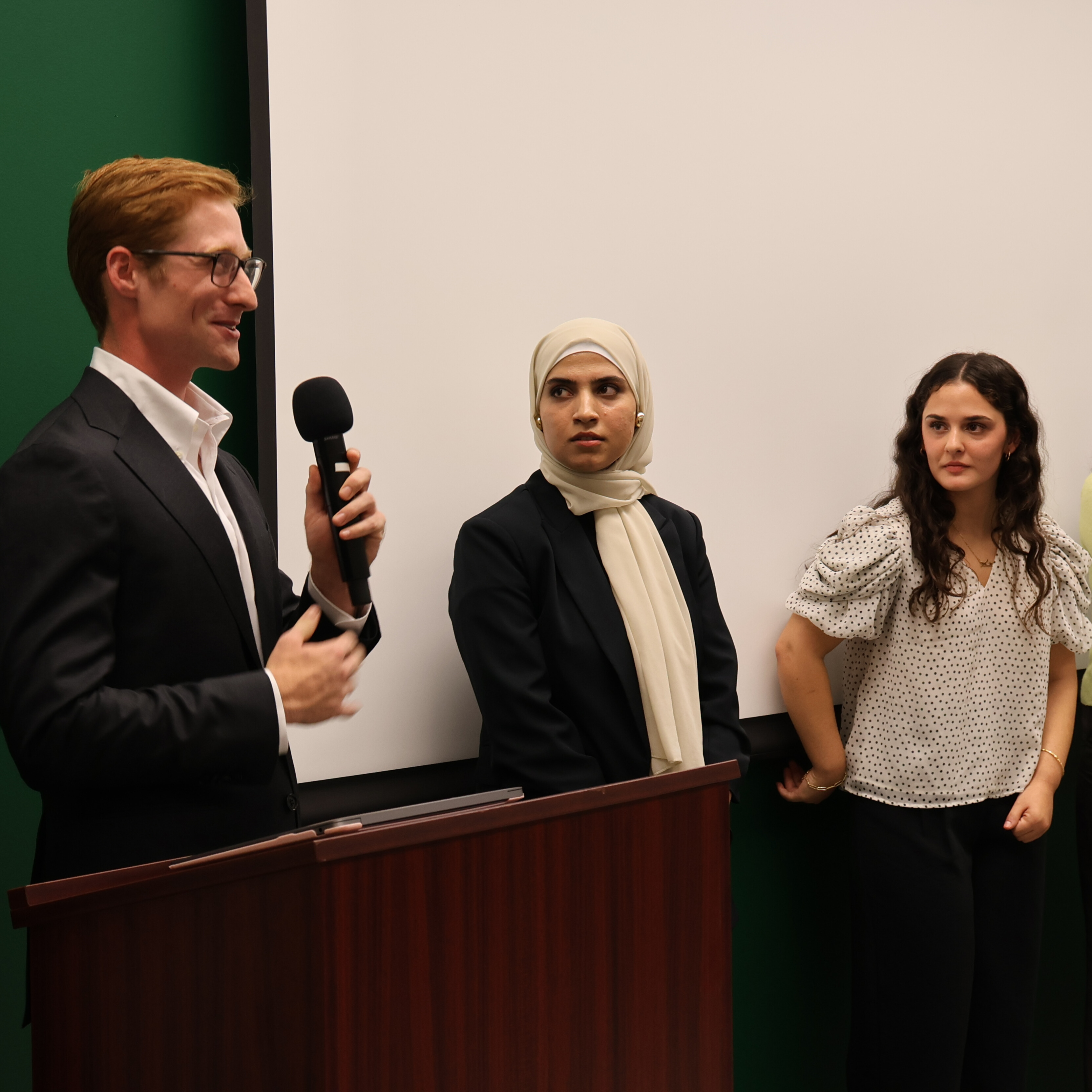 Students gather after presentations to answer audience questions