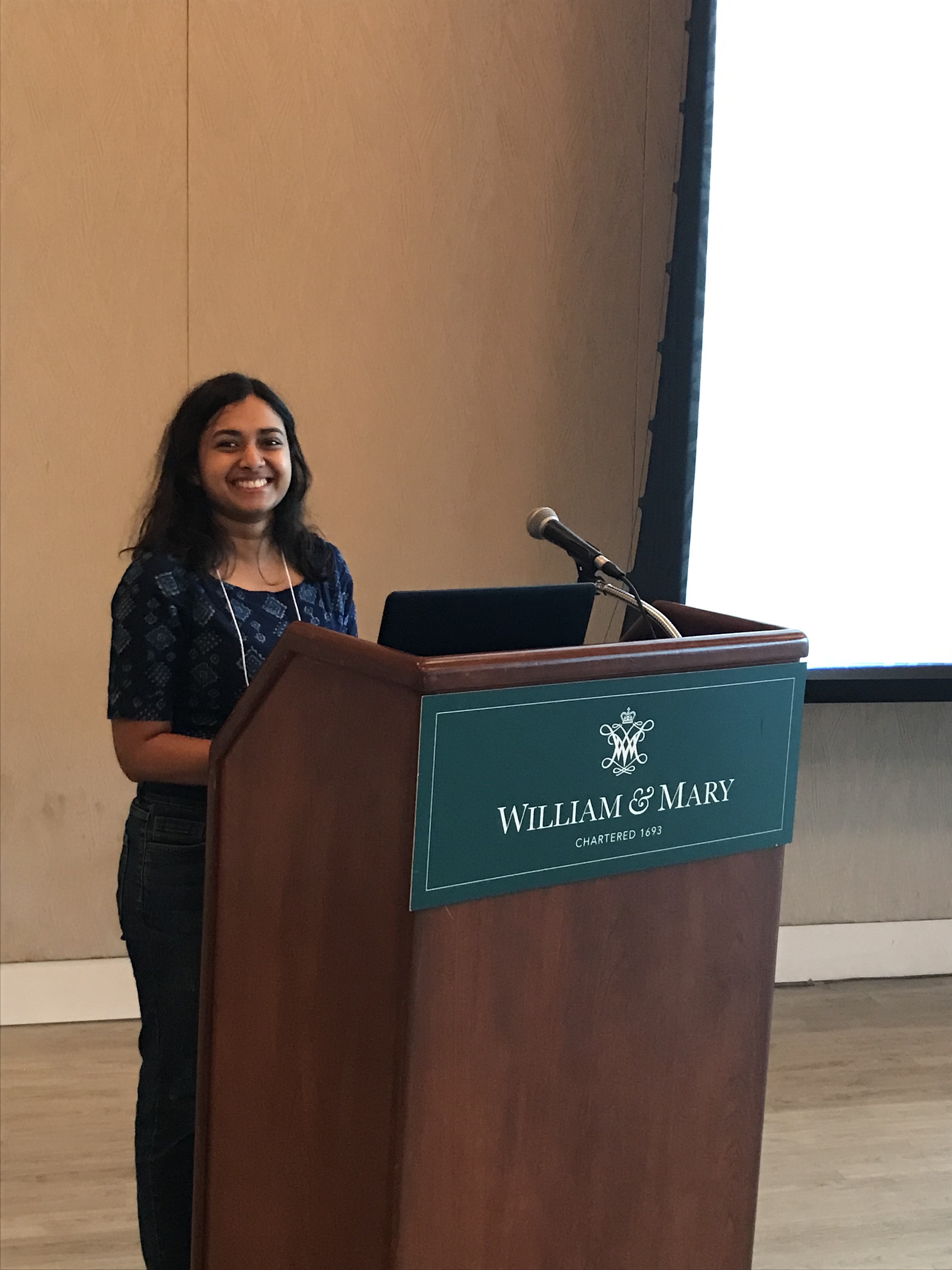 GRS presenter Anu presenting at the podium 