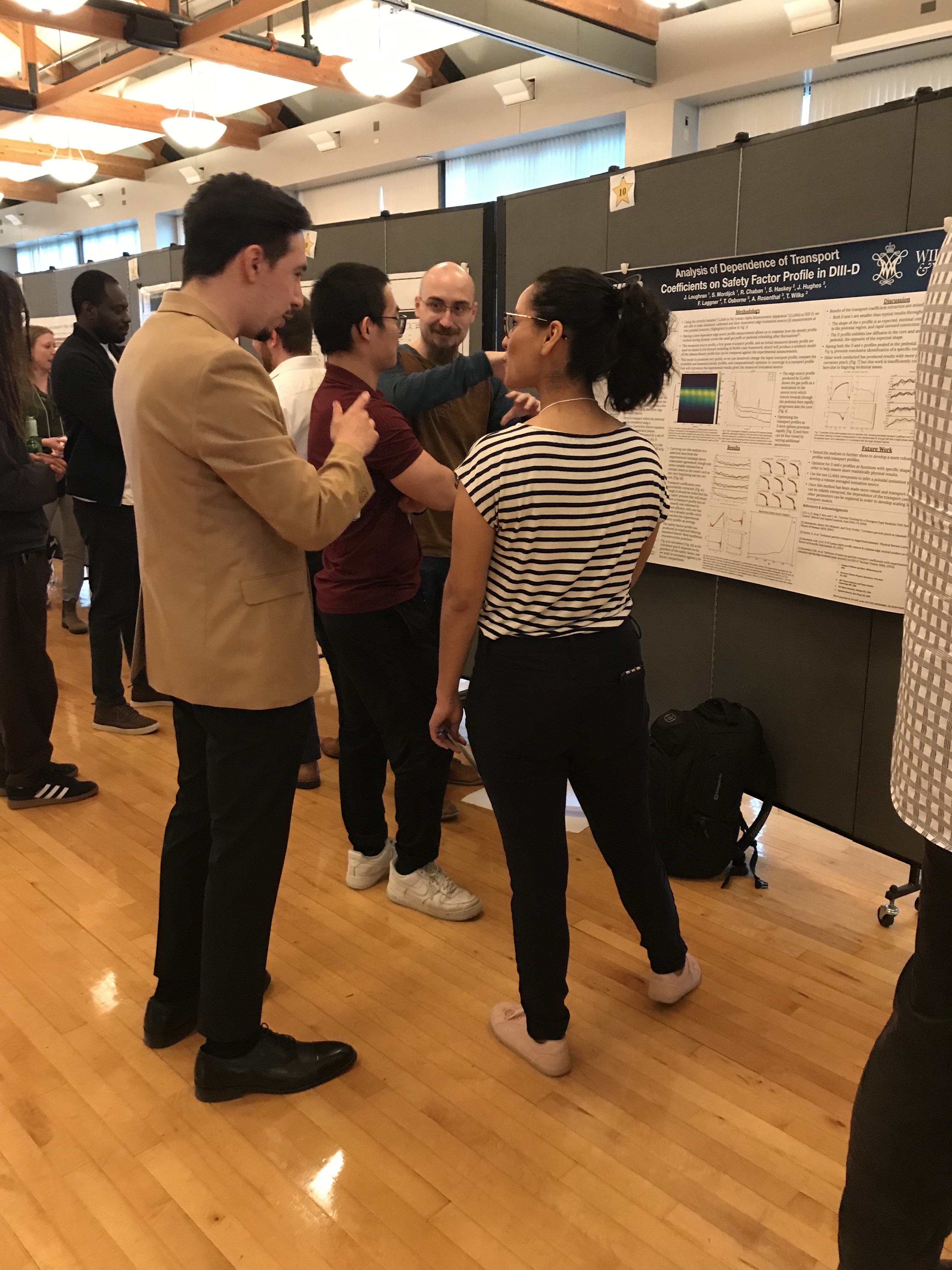 Physics students presenting poster 2023