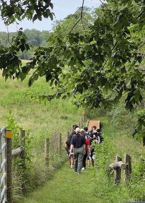A youth group walks with W&amp;M student instructors on Highland's yellow trail to identify plants. Image: Lisa Armstrong