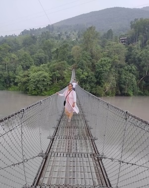 Sapana Lohani, (front), with a CRP field survey team on a suspension bridge over the Marshyangdi River in Lamjung, Nepal.  PHOTO:  Srijan Regmi