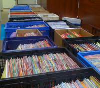 Paper application files like these will now be stored and read digitally.
