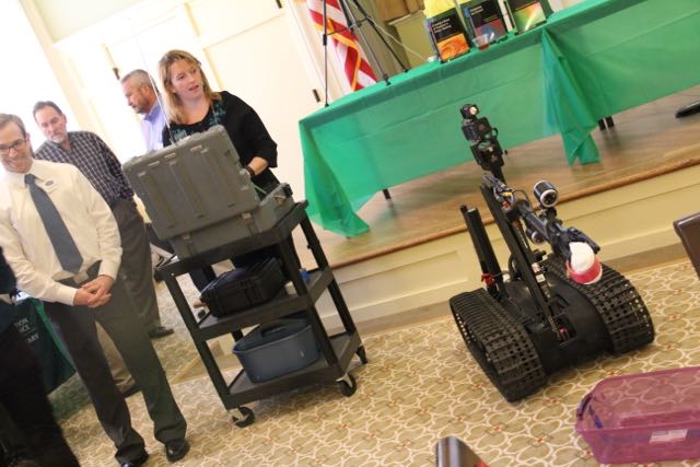 April Lawrence from IT and the School of Education guides the robot to place the bomb (yarn) into a safe zone (the container).