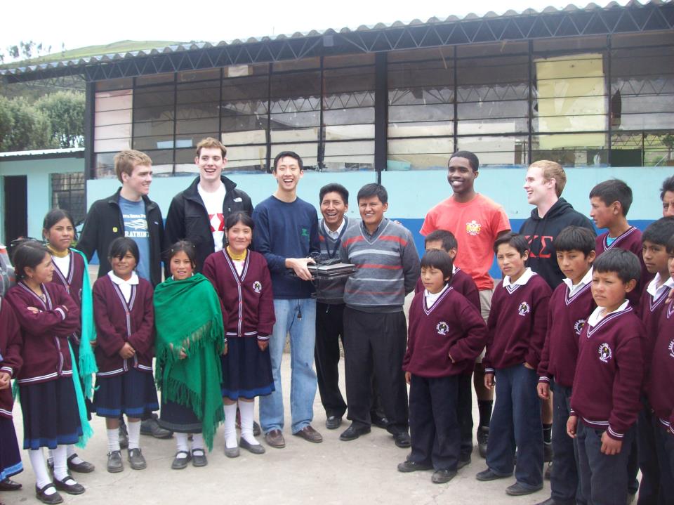 W&M students (left to right) Matthiessen Chatfield-Taylor, Adam Nowicki, Benming Zhang, Seth Opoku-Yeboah, and Patrick Mullin presenting the director of the Manuel Aguilar School with two W&M decommissioned laptops.