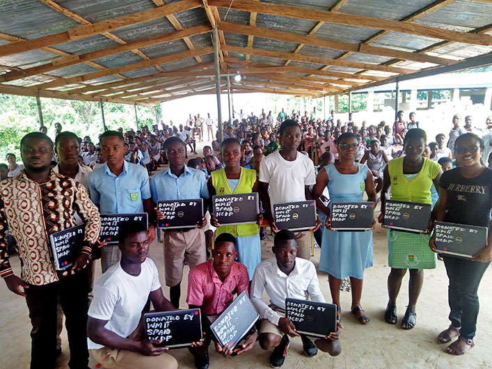 Students in Ghana pose with decommissioned laptops received from William & Mary.