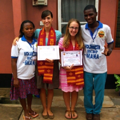 SPIMA Trip Leaders Gloria Driessnack (center left) and Mary Kate Wise (center right) were presented with certificates by members of HCPD-Ghana during their previous service trip to Ghana. Richard Anku, Executive Director of HCPD-Ghana, is on the right.