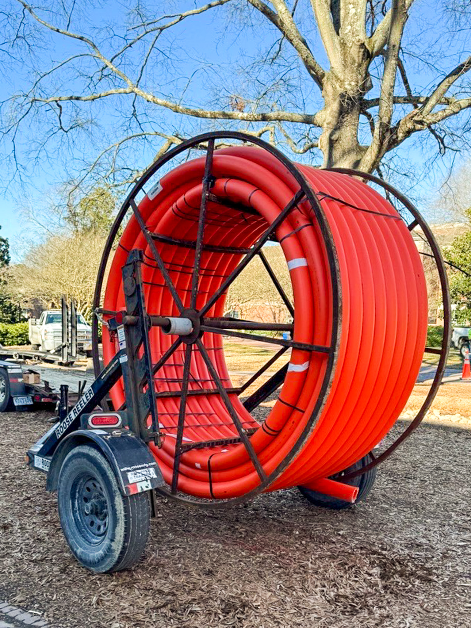 A spool of 4 inch conduit is waiting to be pulled through the newly bored pathways.