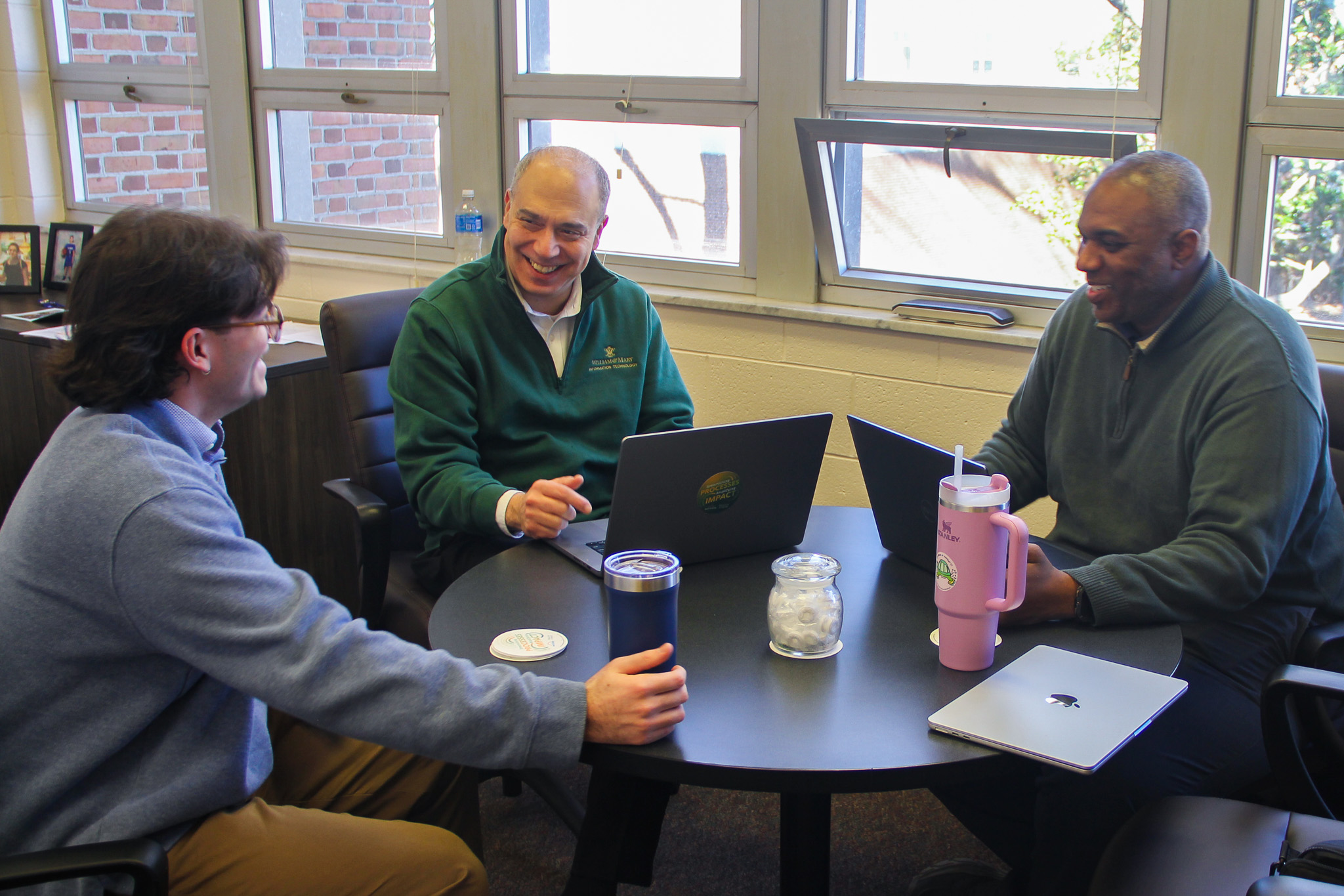 Computer Science Student Sam Oliver speaks with CIO Ed Aractingi and Manager of Innovation and AI Application Administration Louis Hubert during his visit. 