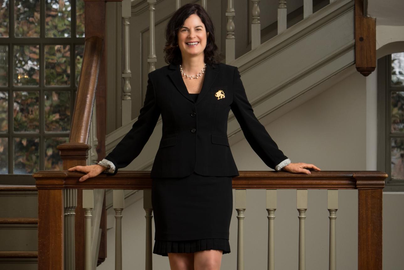 William & Mary President Katherine A. Rowe standing against a banister.