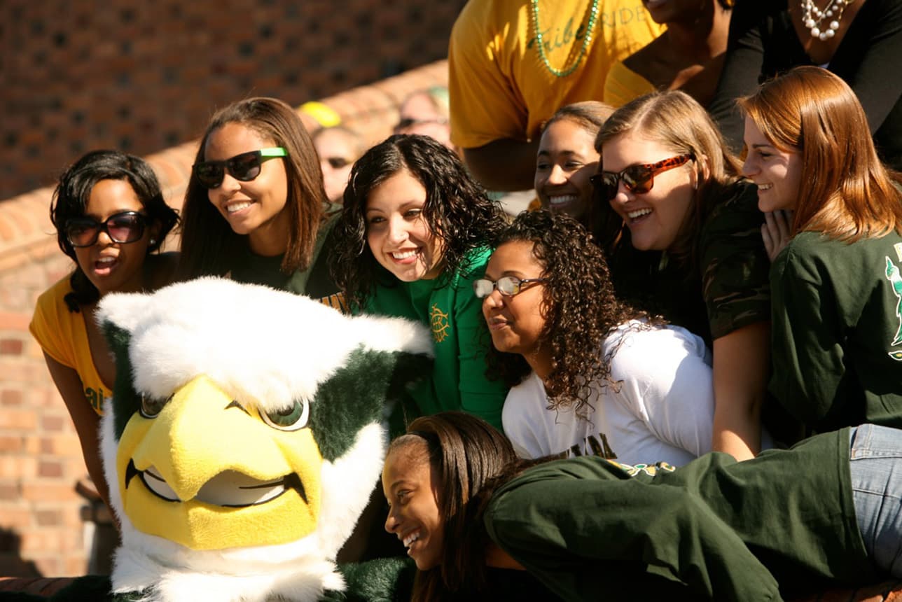 Group of residents posing with the W&M griffin mascot