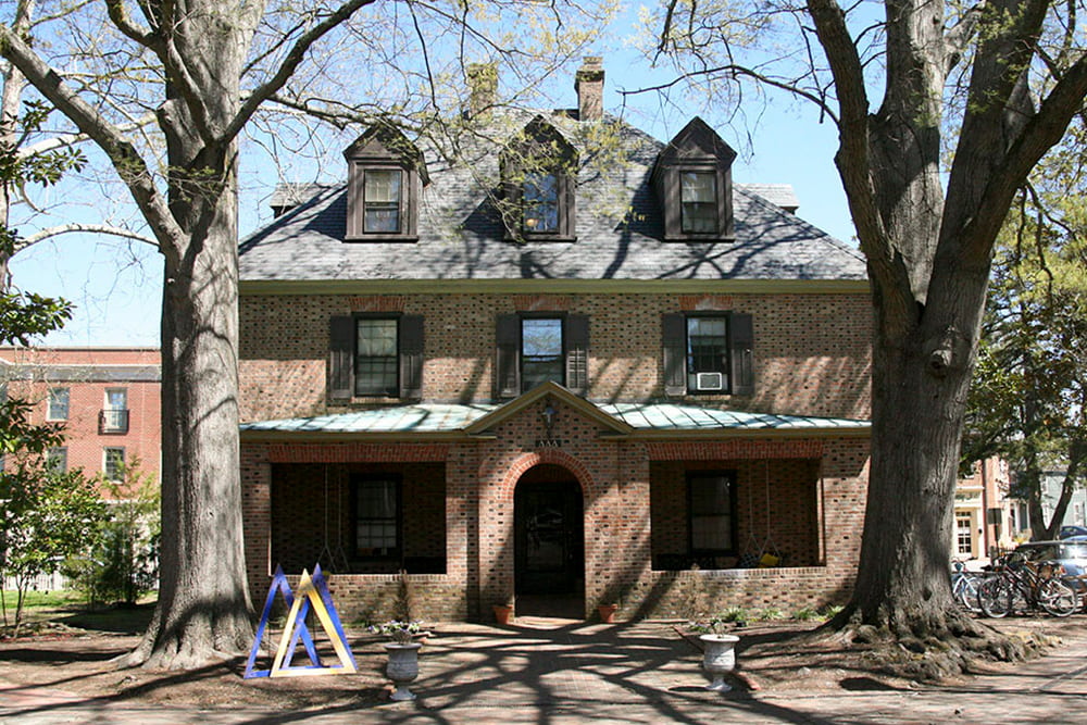 Brick house with dormer windows, slate and copper roof and front porch