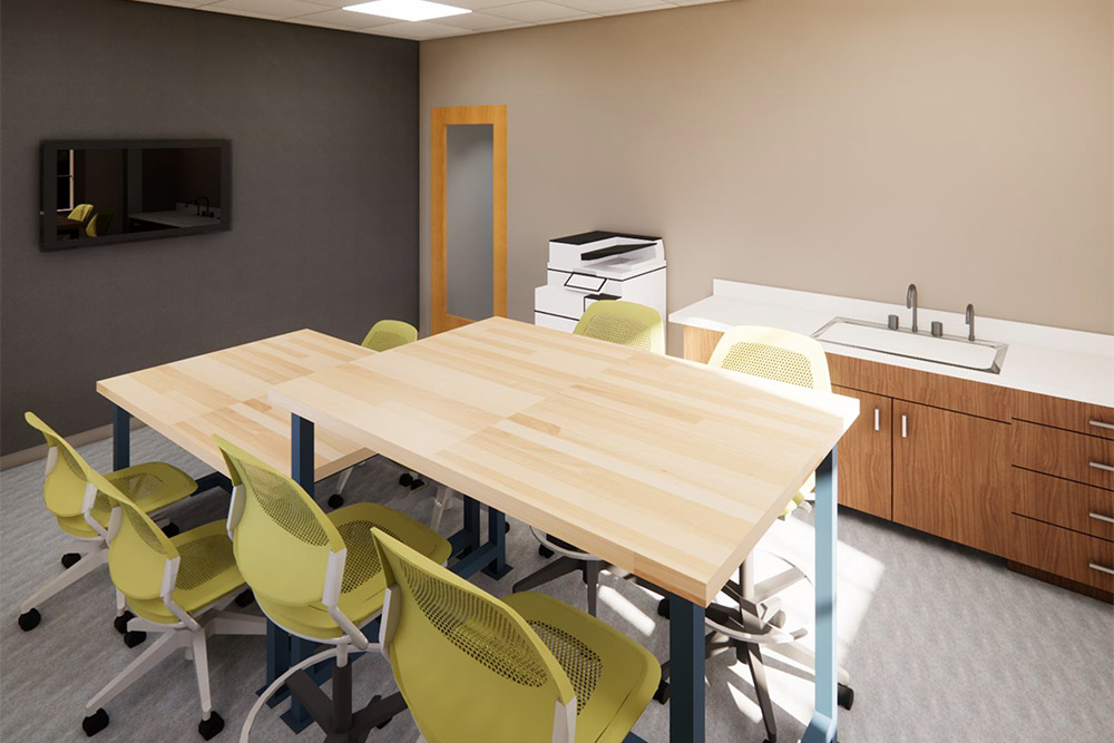 Modern decor room with a wall mounted display, copier/scanner, sink and countertops and multi-tiered re-configurable work tables and chairs