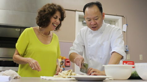 Becca Marcus of the counseling center works with a Peter Chang chef to learn how to cook authentic Chinese cuisine on Oct. 8.