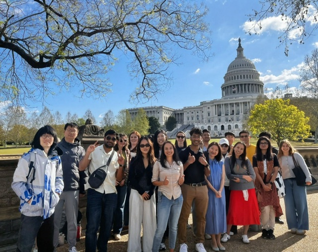 Group of smiling international students standing outside of the U.S. Capitol Building in Washington, D.C.