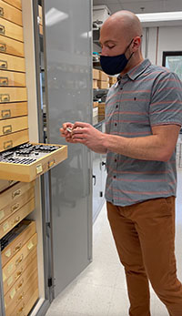 Doctoral candidate Andrew Corso prepares to analyze a vial of Antarctic silverfish from the Nunnally Ichthyology Collection at VIMS. © Laura Patrick/VIMS.