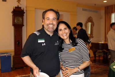 Andrew Martin with Rocio Bresnahan, administrative coordinator and building manager of the Reves Center, at a reception in the Reves Room for international students and scholars, their families and campus partners. Martin and Bresnahan were colleagues at Literacy for Life. (Photo credit: Kate Hoving);
