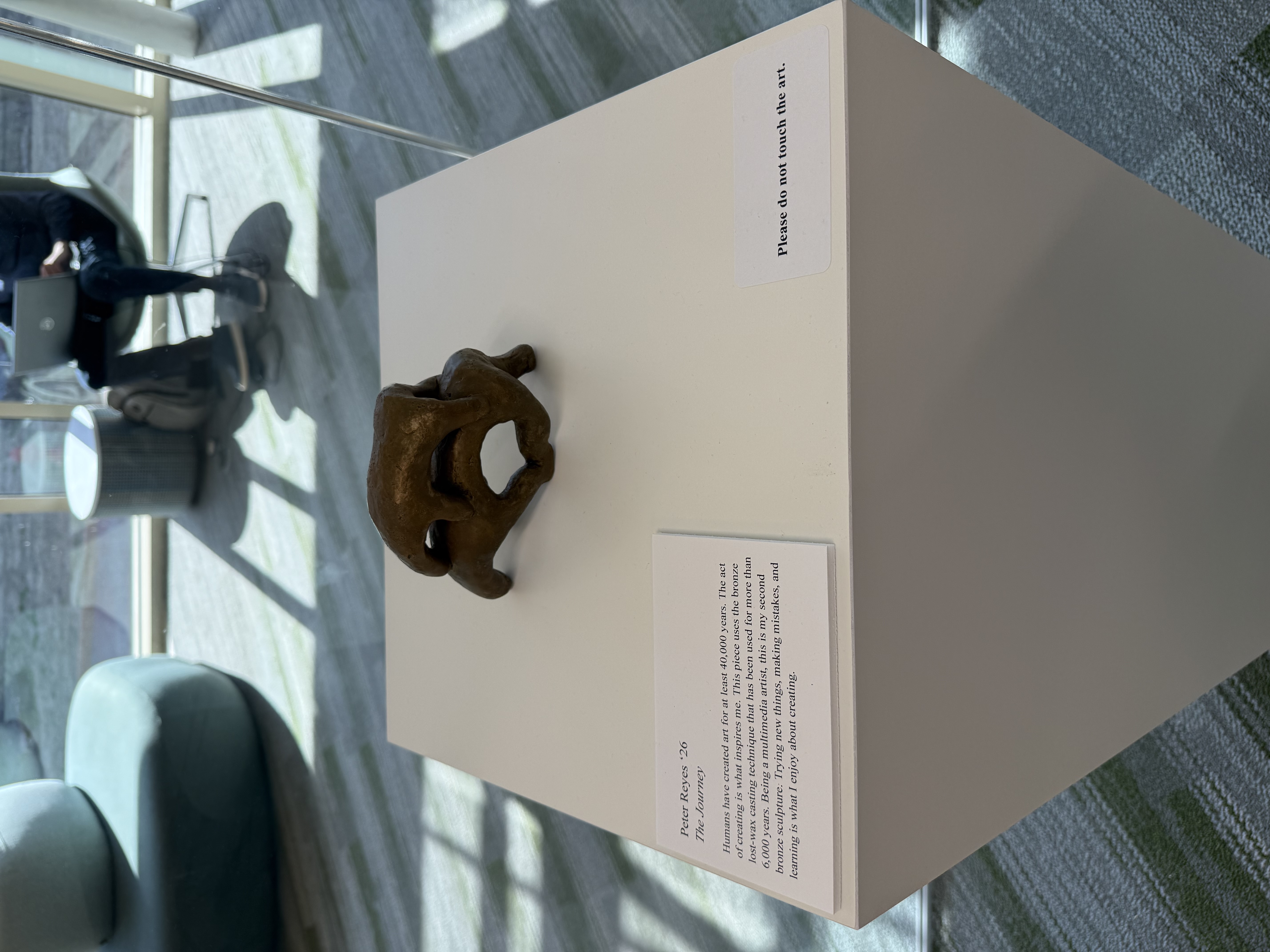 Multimedia artist Peter Reyes ‘26 displays his second bronze sculpture, The Journey, which conveys the history of making art by using a lost-wax casting technique. (Photo courtesy of Rebecca Graber ‘27) 
