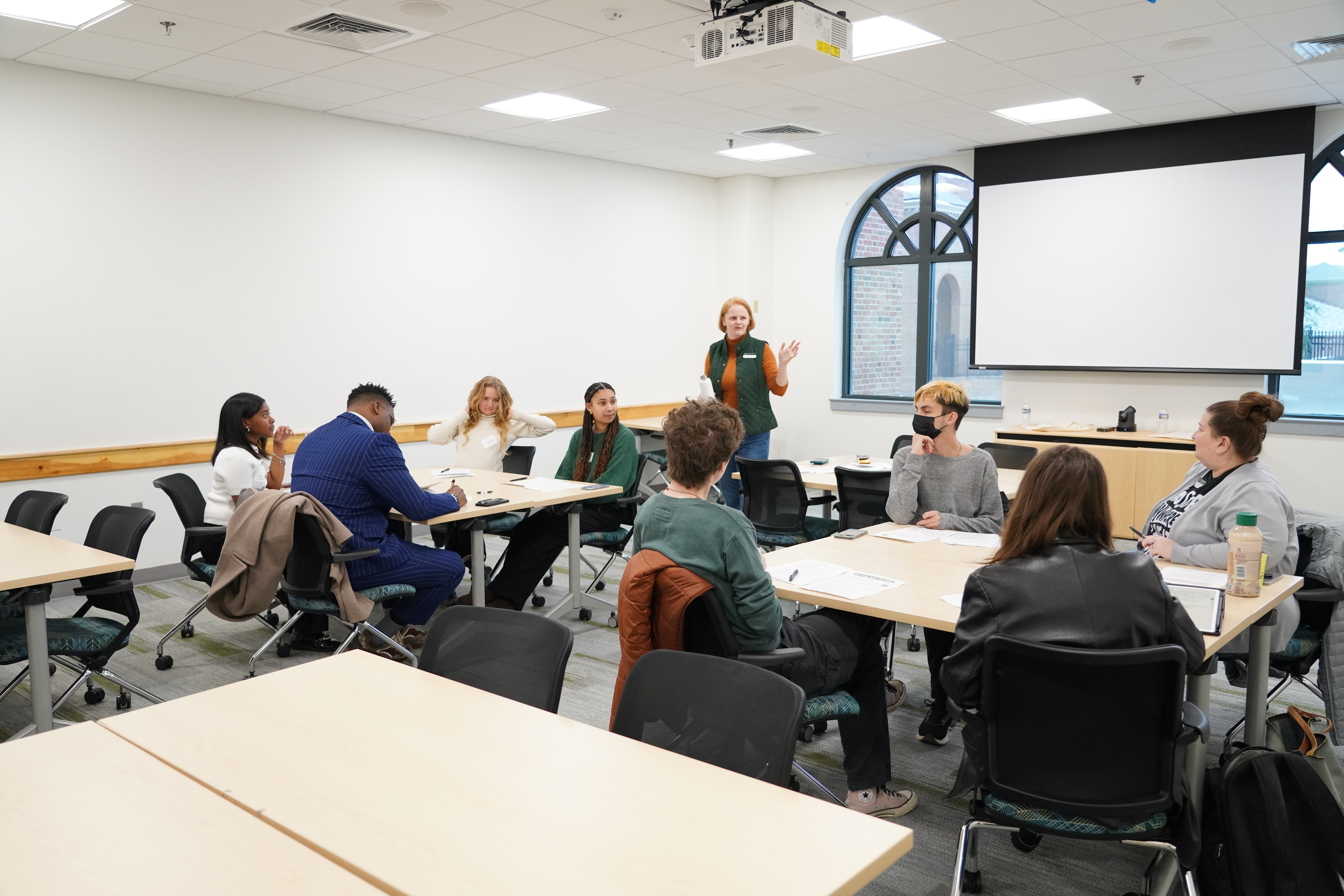 Elizabeth Miller leads a civic action breakout session during the Martin Luther King Commemoration Summit. She guides student curiosity in developing practical goals and steps for action.