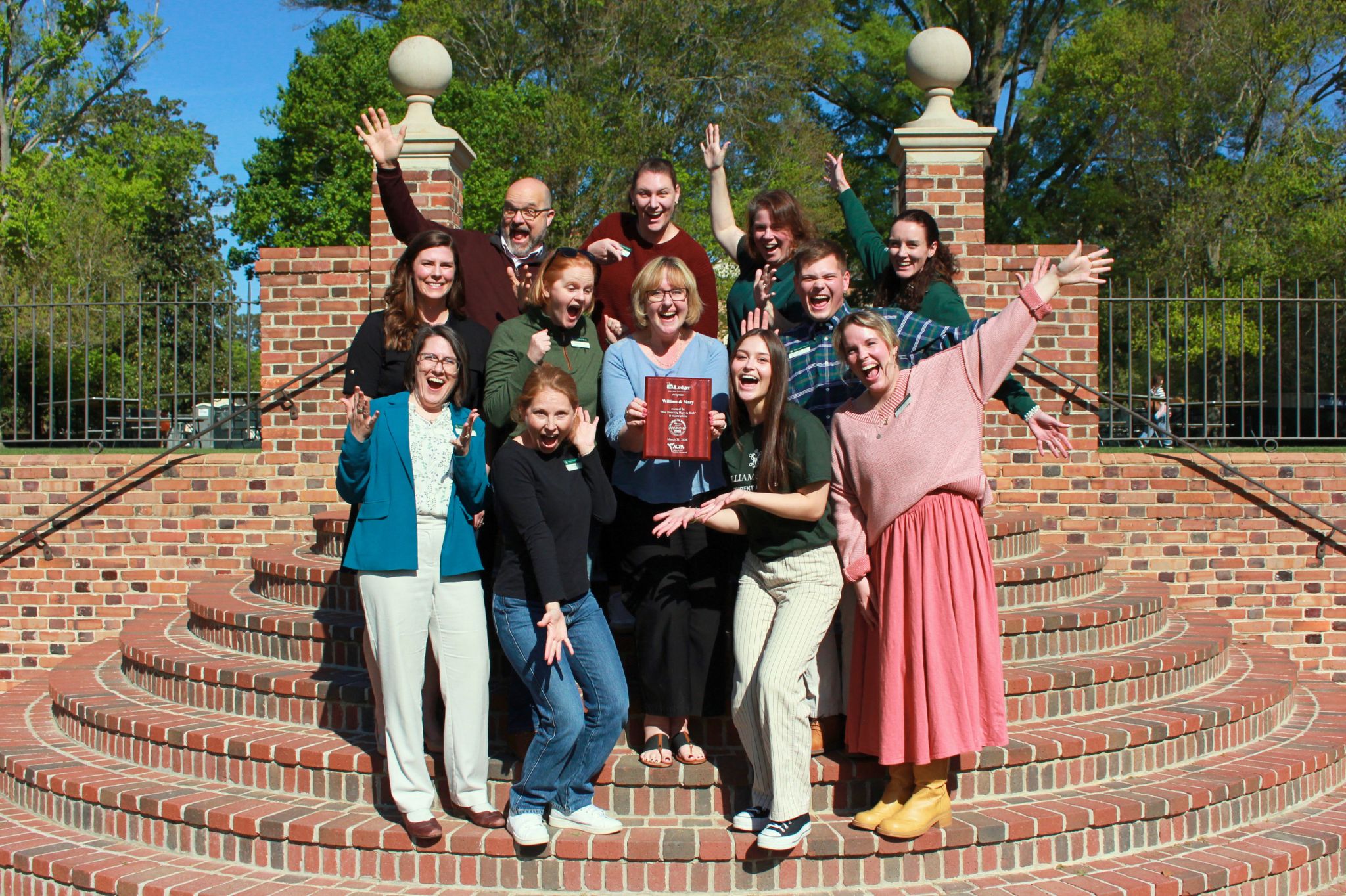 Student Affairs staff gather on the steps of the Sunken Garden to celebrate being named a Most Promising Place to Work in Student Affairs for the 11th time since 2014.