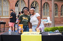 Two students pose for the camera at the CSD Block Party welcoming new students