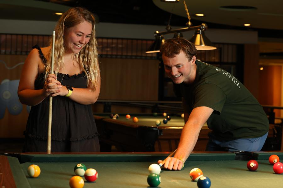 Two students playing pool
