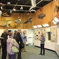 Visitors listen to a presentation at the VIMS Visitors Center (Photo courtesy of VIMS)
