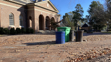 Trash, recycling, and compost bins outside Tucker Hall