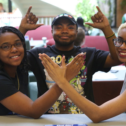 three students tabling to raise funds and awareness for March of Dimes