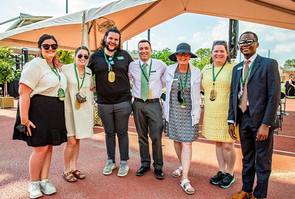 A group of seven William & Mary employees smile for a group photo.