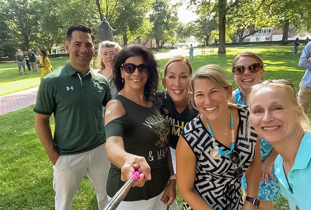 Several William & Mary employees smile for a selfie stick photo.