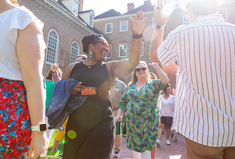 William & Mary employees giving high fives at employee convocation.